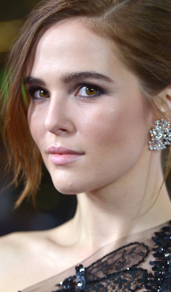 Stylish brown-eyed girl, actress Zoe Deutsch in a black dress