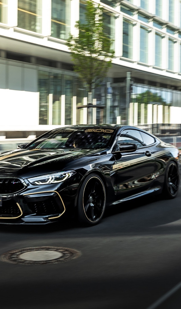 Черный стильный автомобиль BMW Manhart MH8 800, 2020 года на улице города