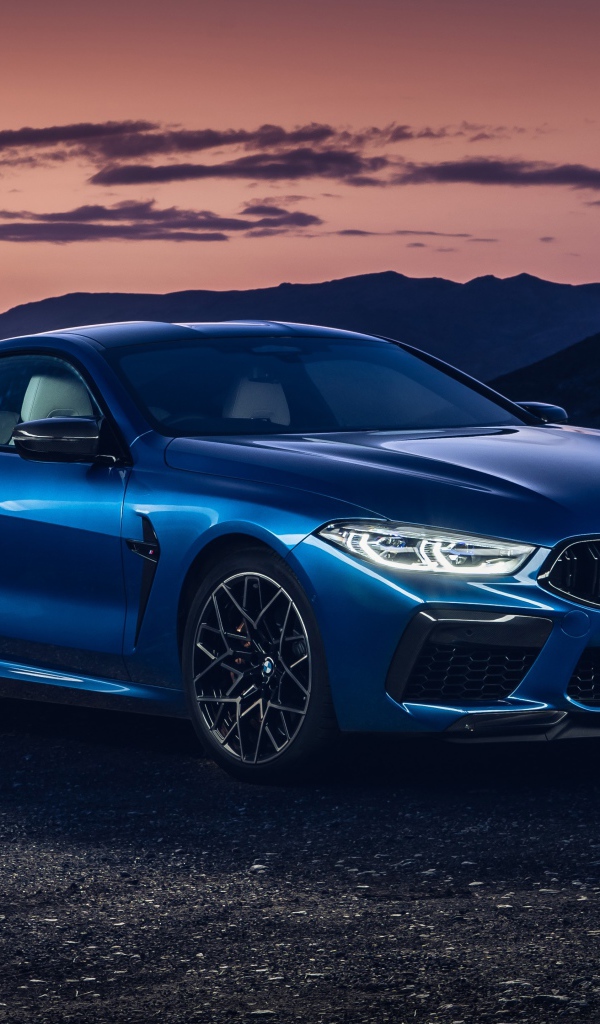 Синий автомобиль BMW M8, 2019 года на фоне гор