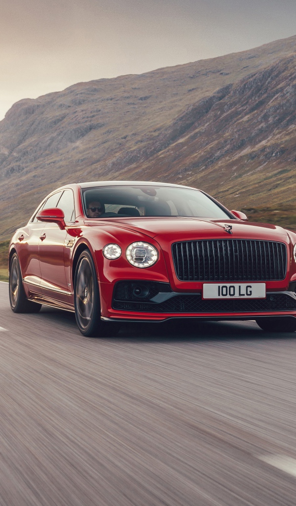 Красный автомобиль Bentley Flying Spur V8 2020 года на дороге  