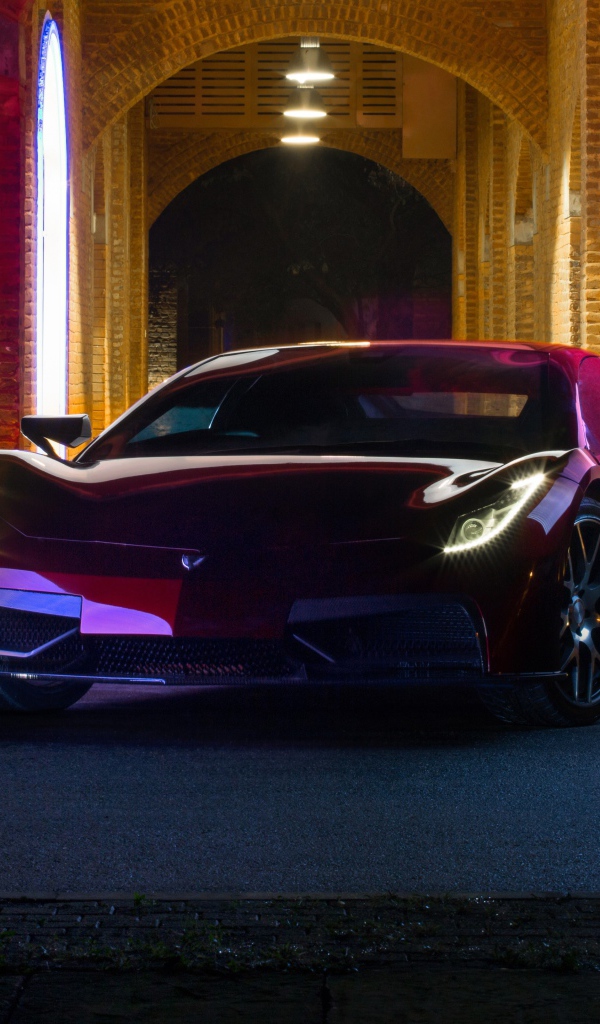Красный автомобиль Vega EVX 2020 года у дома