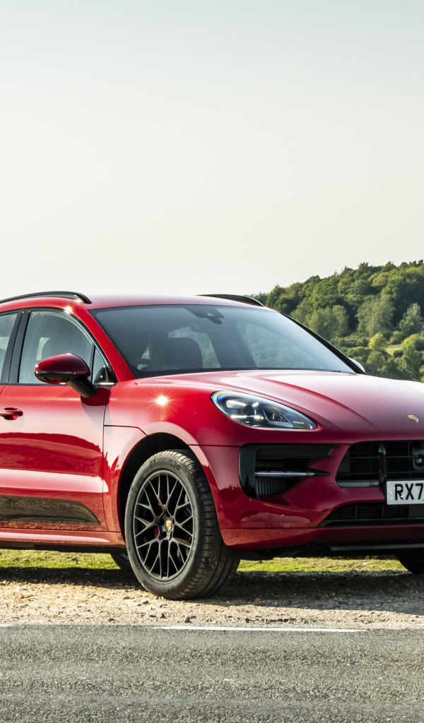 Красный автомобиль Porsche Macan GTS 2020  года в лучах солнца