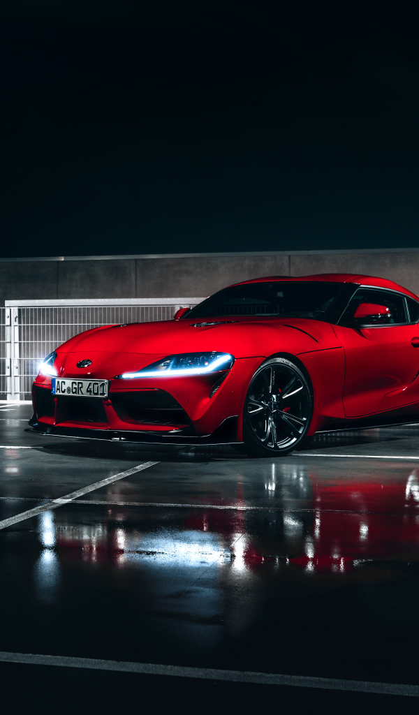Красный автомобиль Toyota GR Supra AC Schnitzer 2019 года у гаража