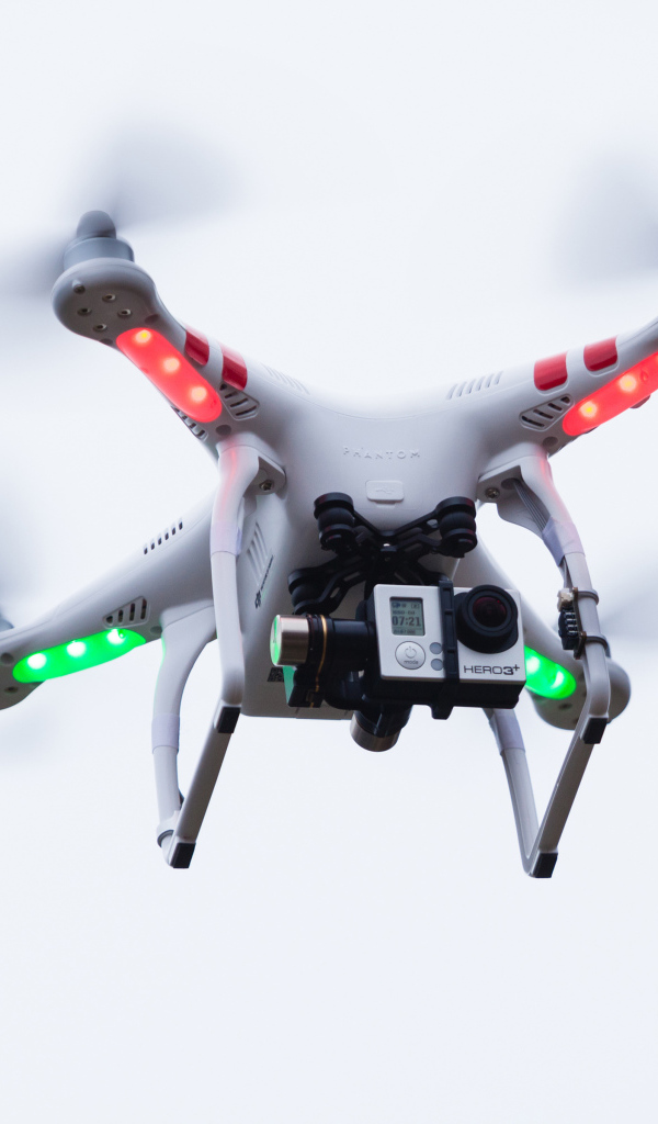 Quadrocopter with a video camera on a white background