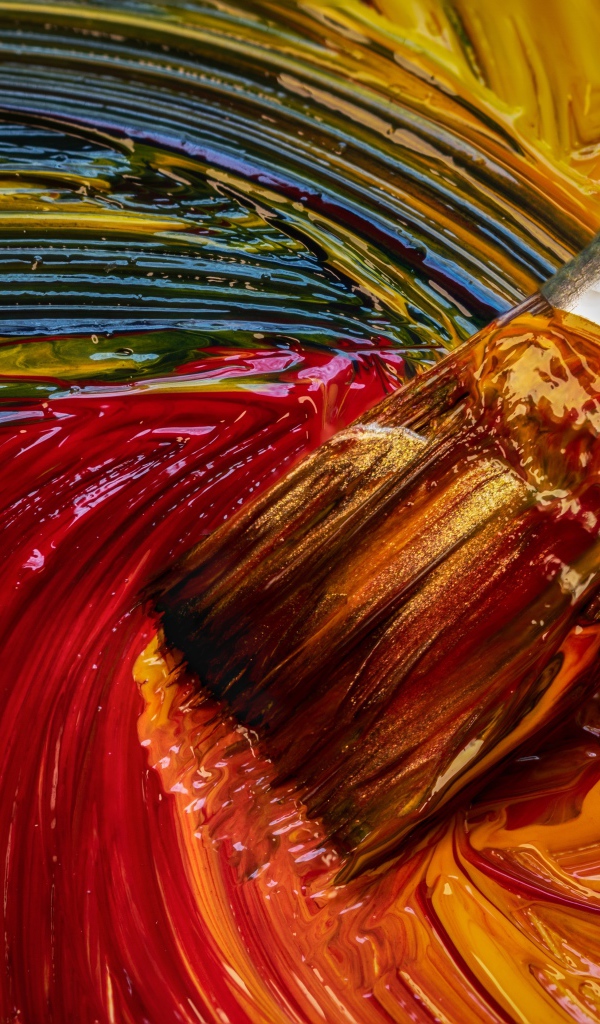 Brush mixes paints in a palette