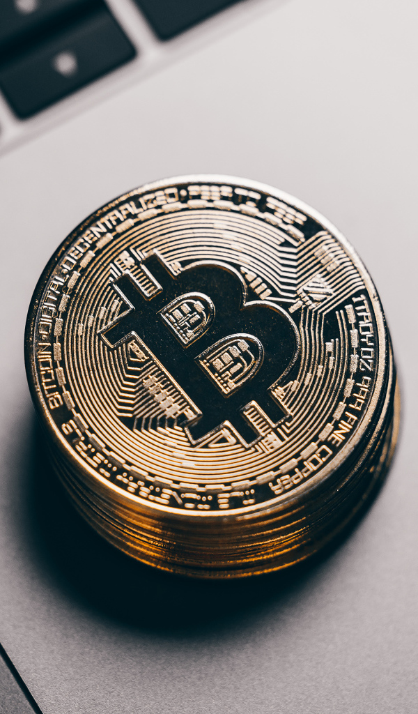 Bitcoin coins lie on a laptop