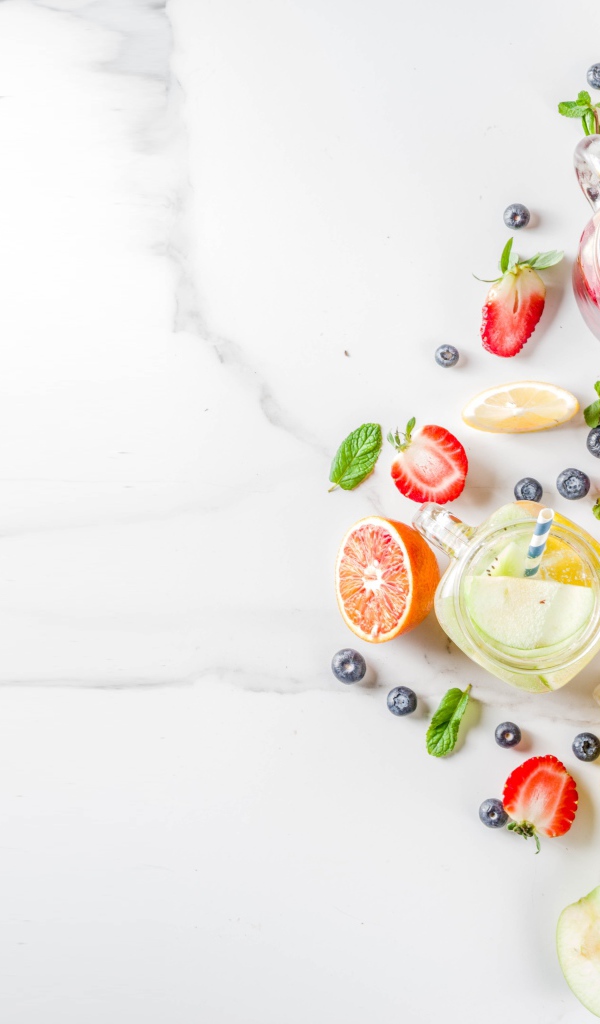 Смузи в баночках на столе с ягодами и фруктами