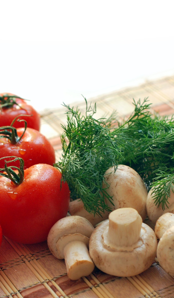 Tomatoes on the table with dill and champignons
