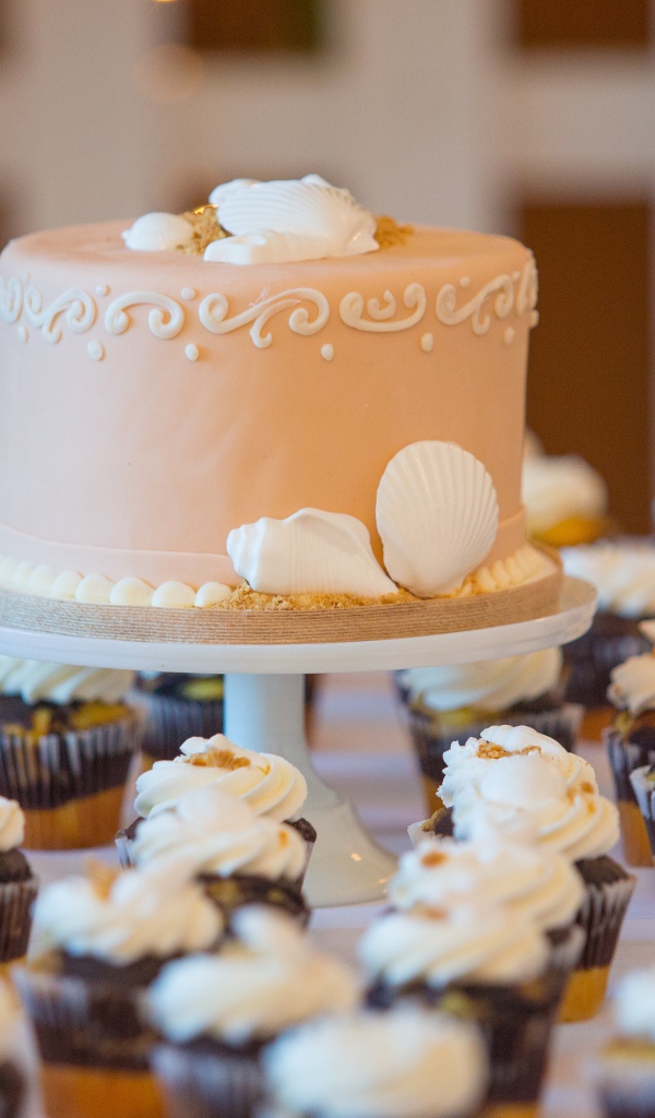 Праздничный торт с пирожными на столе 