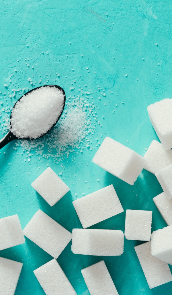 Кусочки сахара рафинада на голубом столе