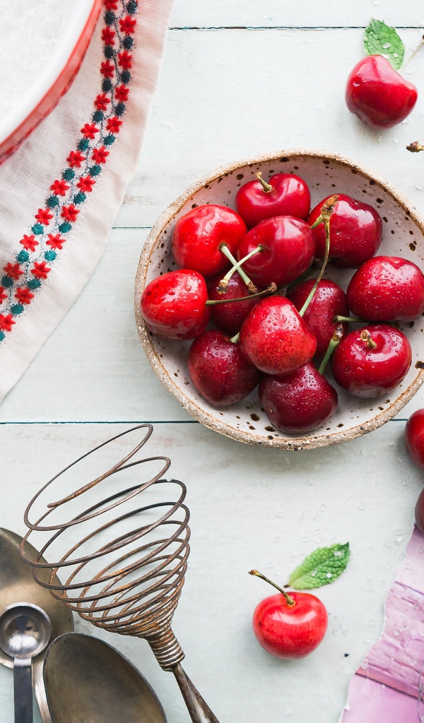 Мокрые ягоды черешни на столе с пирожным