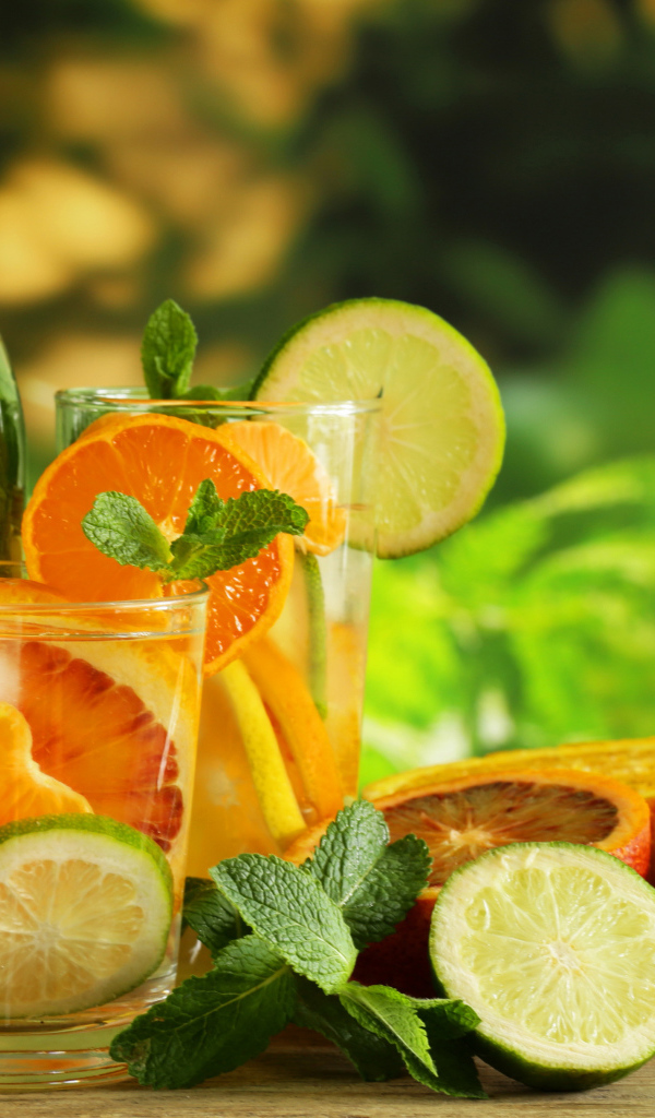 Холодный лимонад на столе с цитрусовыми