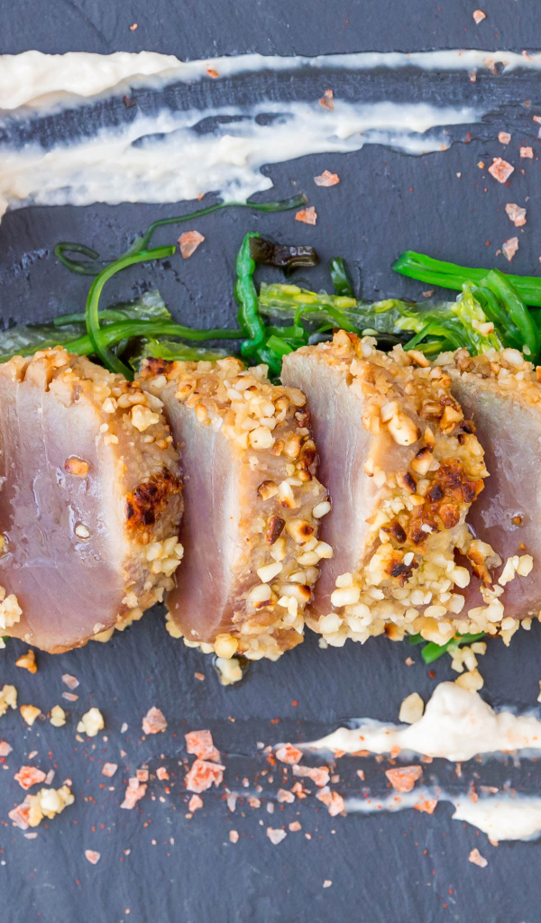 Вяленое мясо на столе с зеленью и помидором 