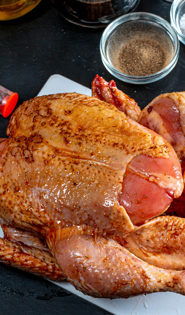 Сырая курица со специями на столе 