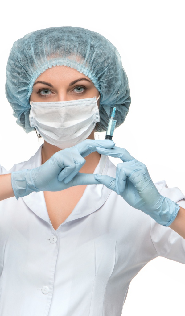 Girl nurse in a mask with a syringe in her hands on a white background