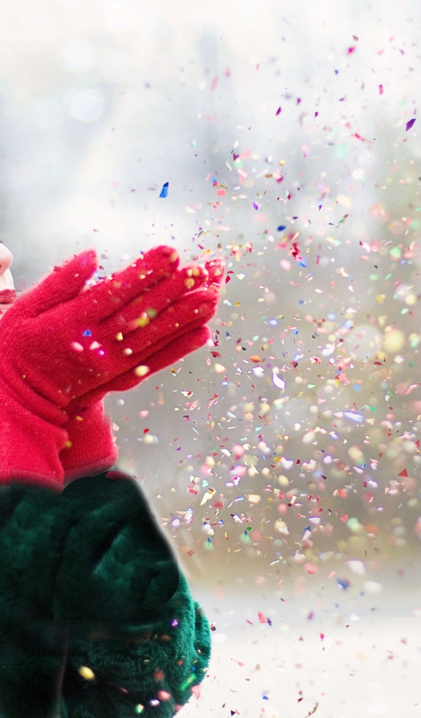 Woman in a fur coat blows off confetti from her palms