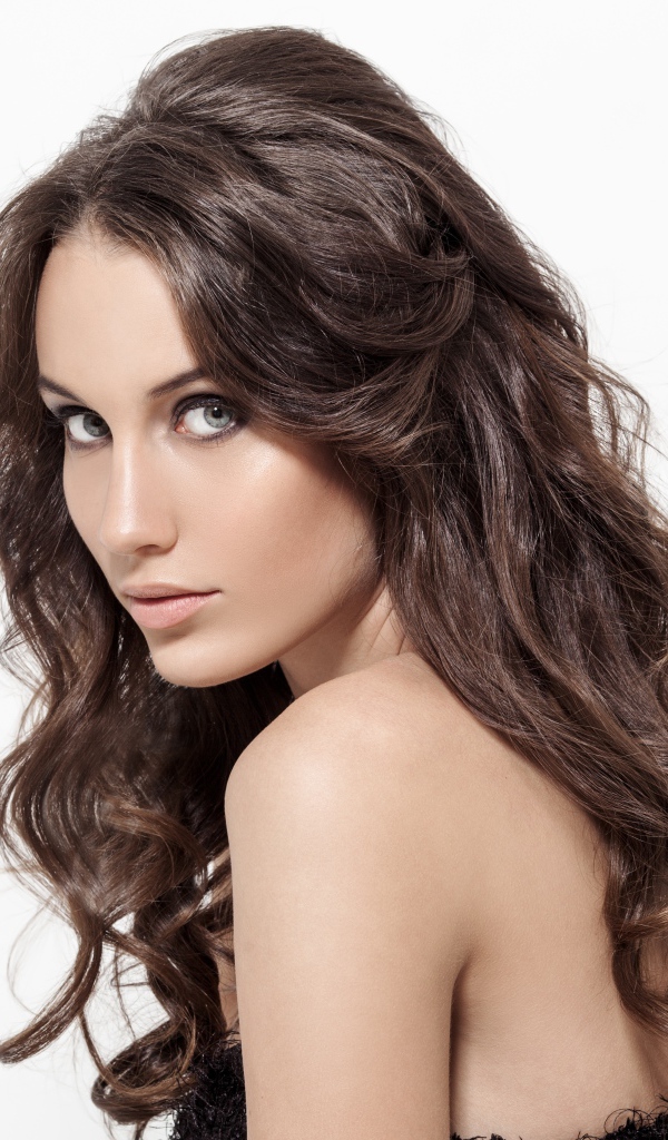 Красивая длинноволосая девушка шатенка на белом фоне 