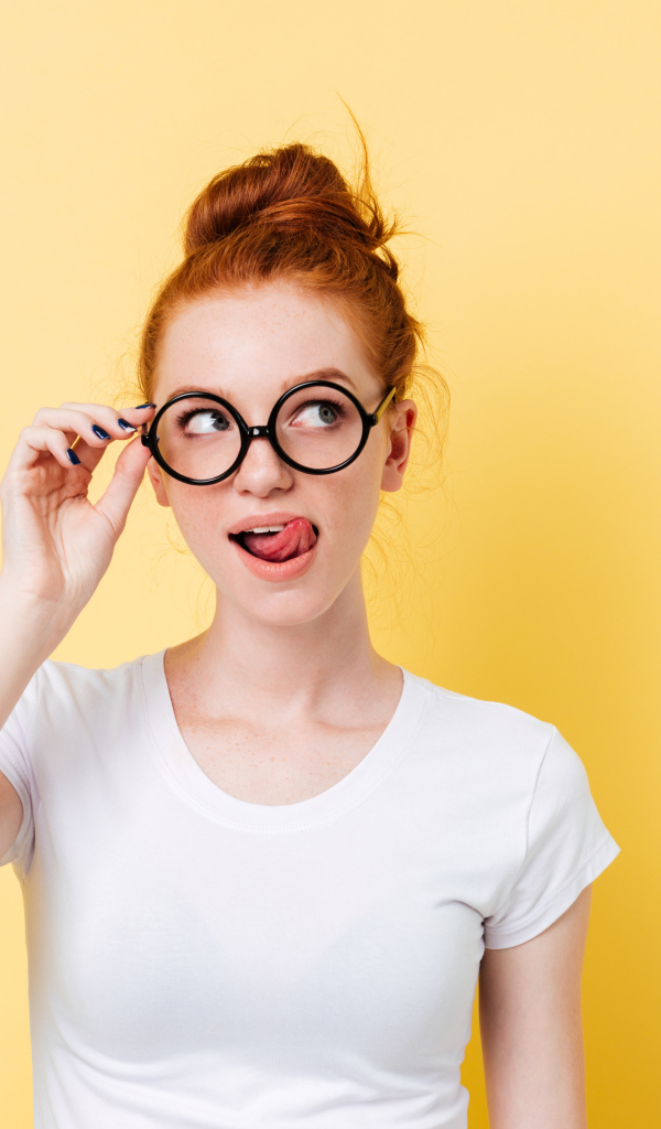 Красивая девушка в очках на желтом фоне 