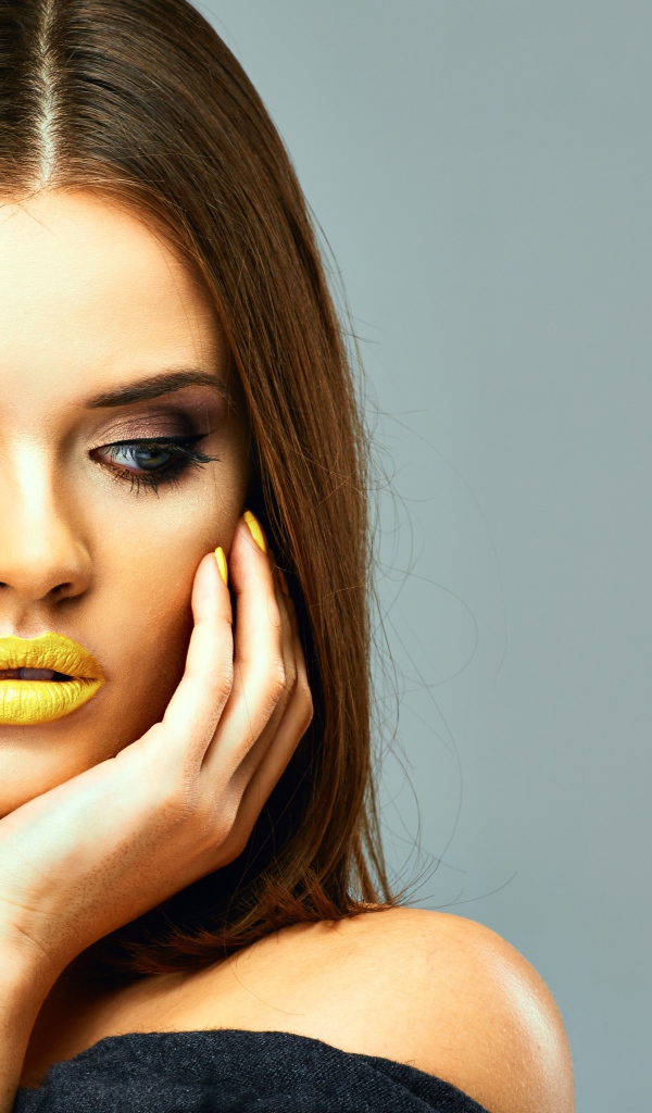 Красивая девушка с желтыми губами на сером фоне