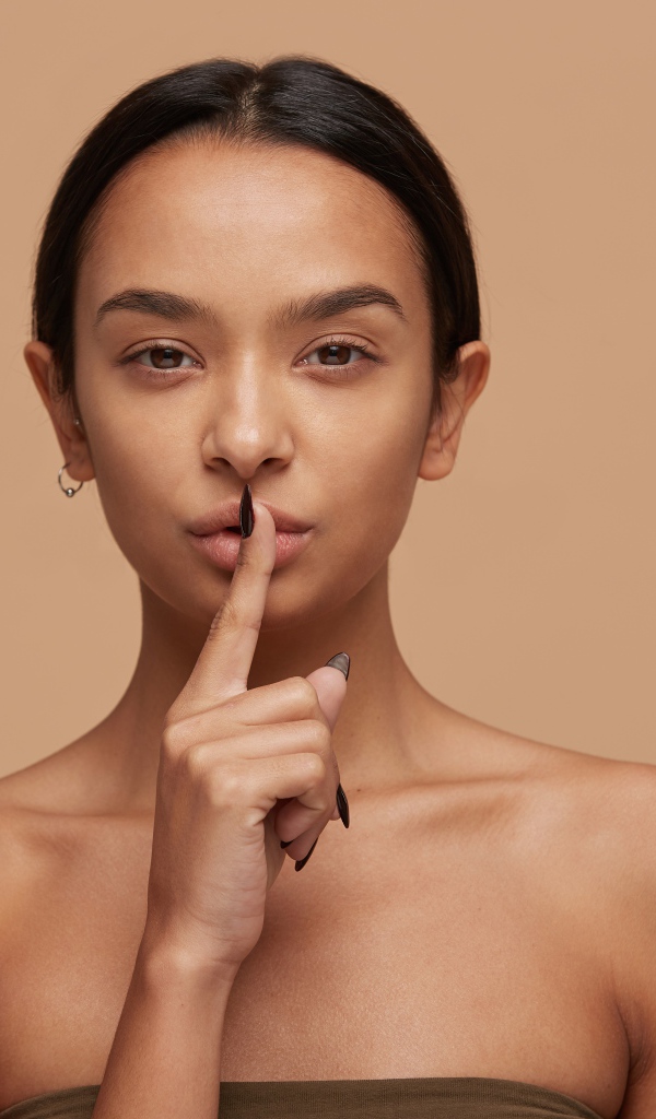 Кареглазая девушка просит соблюдать тишину 