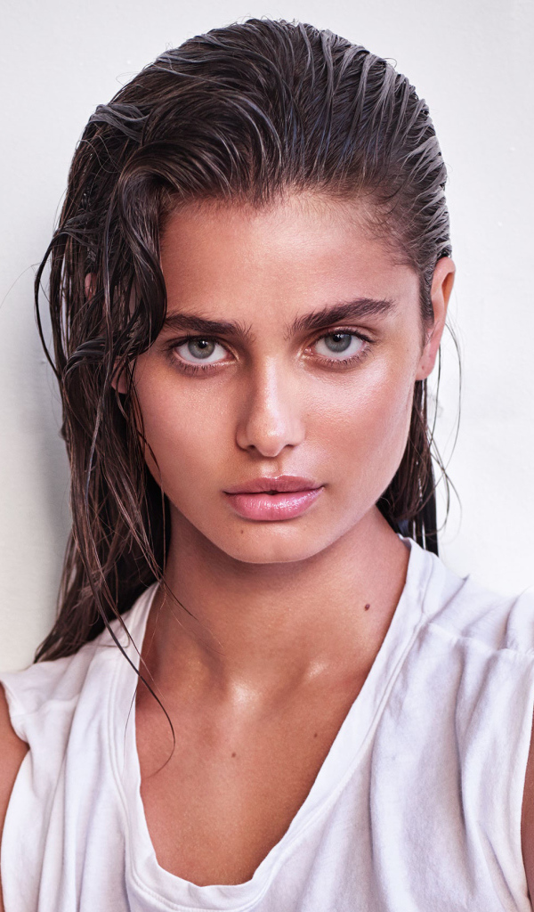 Girl with wet hair, model Taylor Hill on a white background