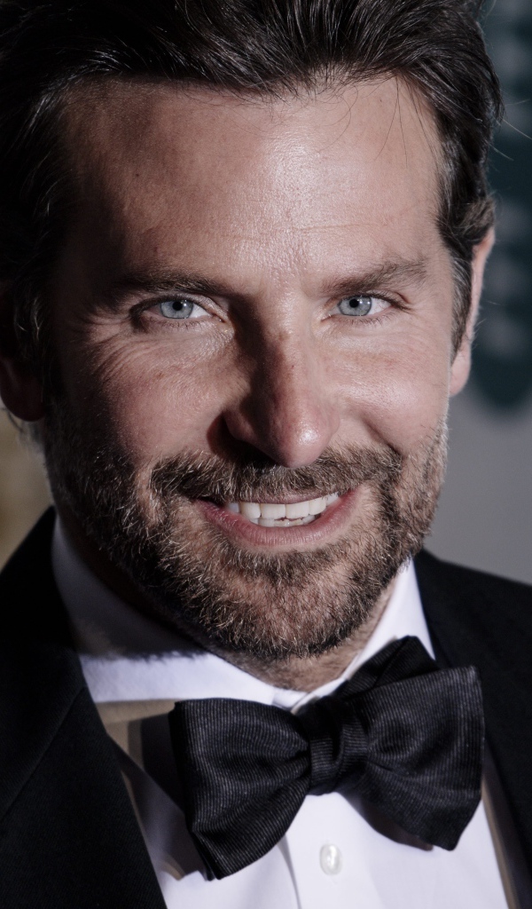 Улыбающийся актер Брэдли Купер в костюме