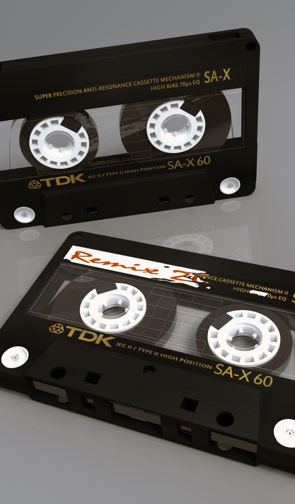 Two TDK cassettes on a gray background