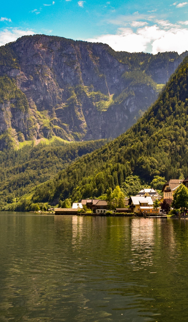 Дома на берегу спокойного горного озера летом