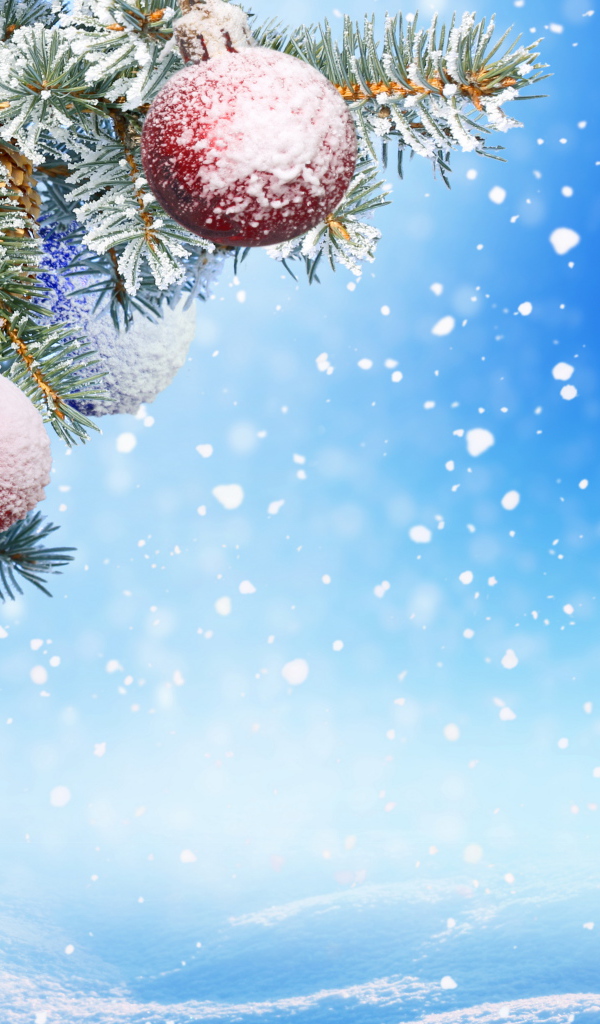 Еловая ветка с игрушками на голубом фоне на Новый год 