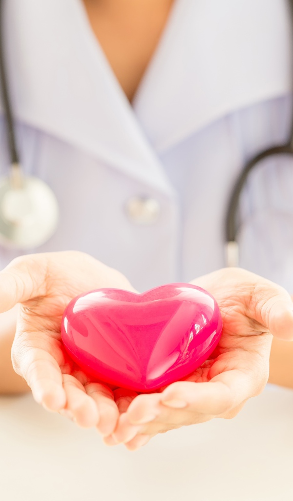 Glass heart in the hands of a doctor