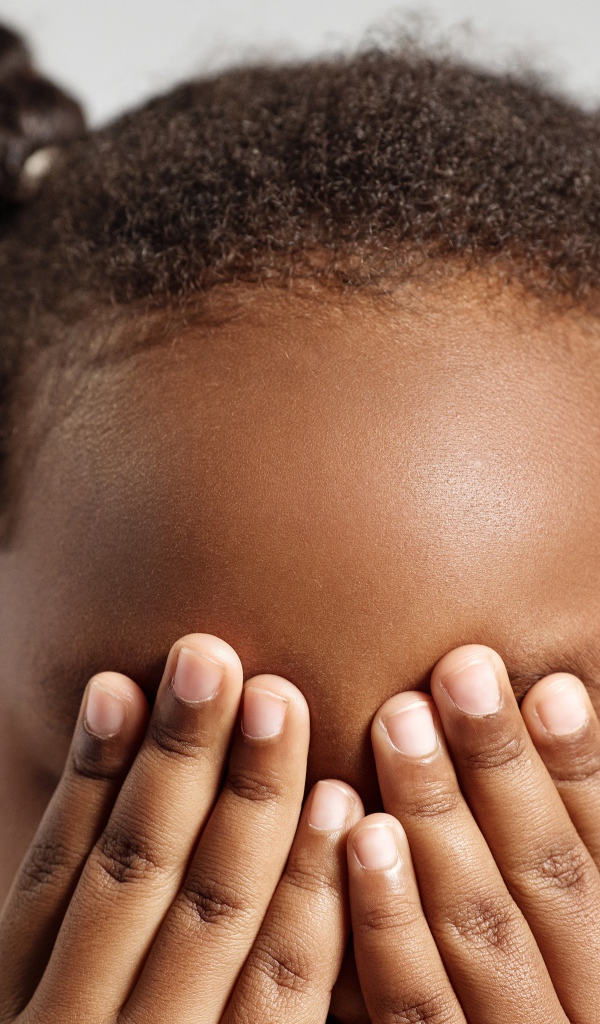 Темнокожая девочка закрыла глаза 