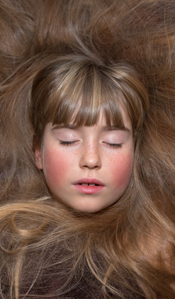 Маленькая спящая девочка с длинными волосами