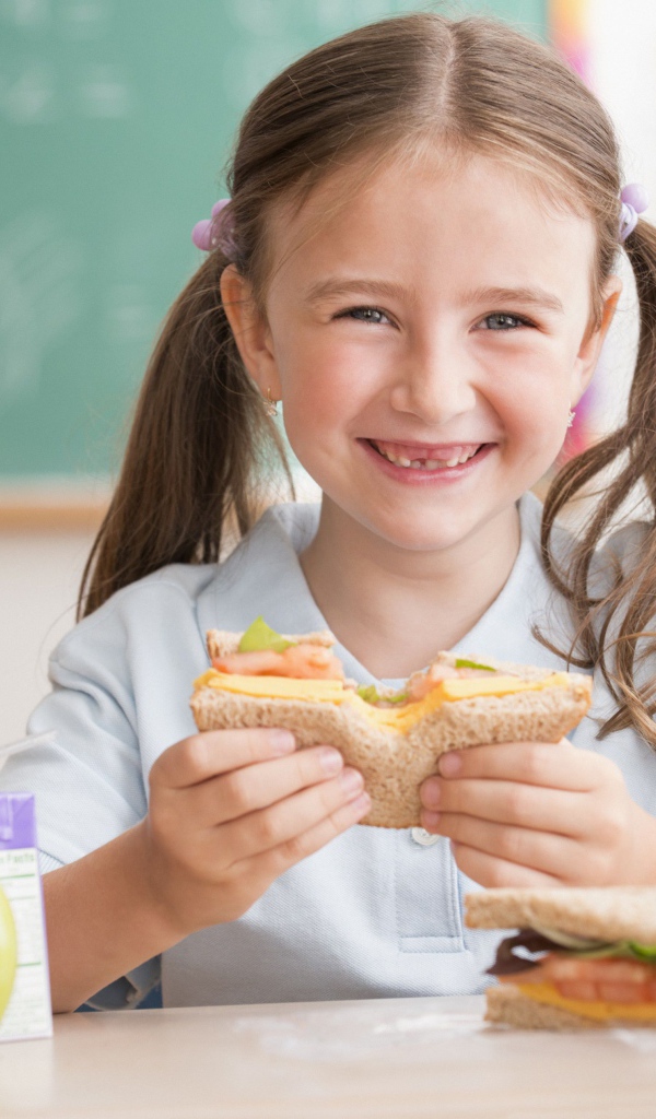 Улыбающаяся девушка школьница в столовой 