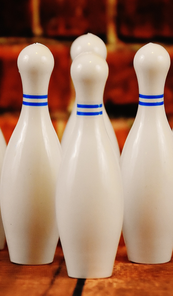Белые кегли стоят у стены 