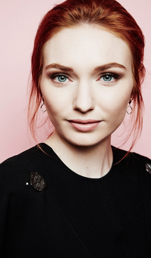 Beautiful red-haired actress Eleanor Tomlinson on a pink background