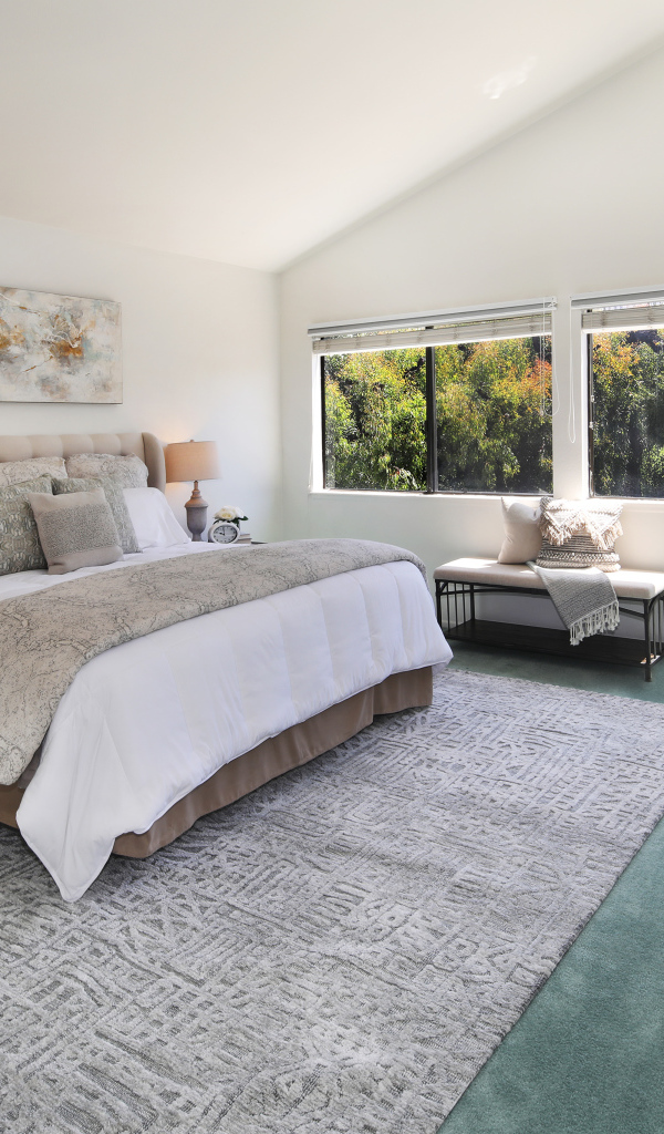 Gray bedroom interior with king size bed.