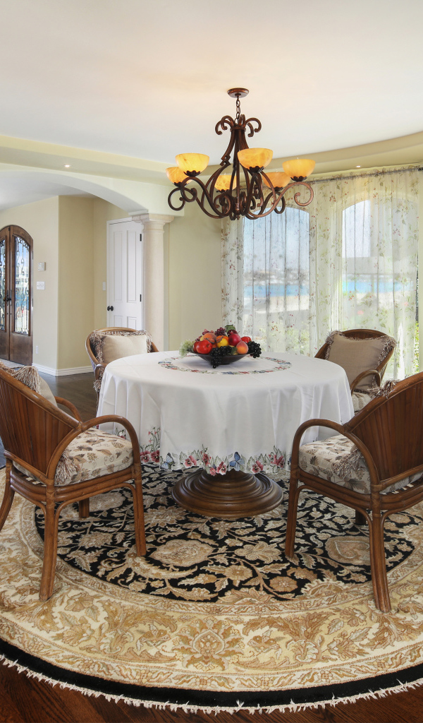 Большая гостиная комната с большими окнами и столом 