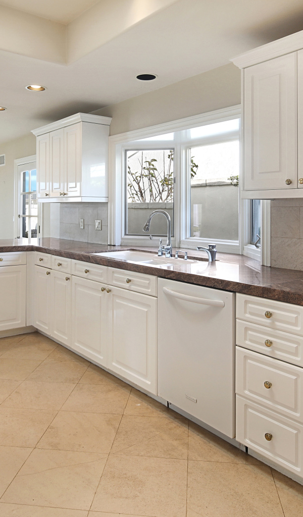 Большая белая кухня с окнами 