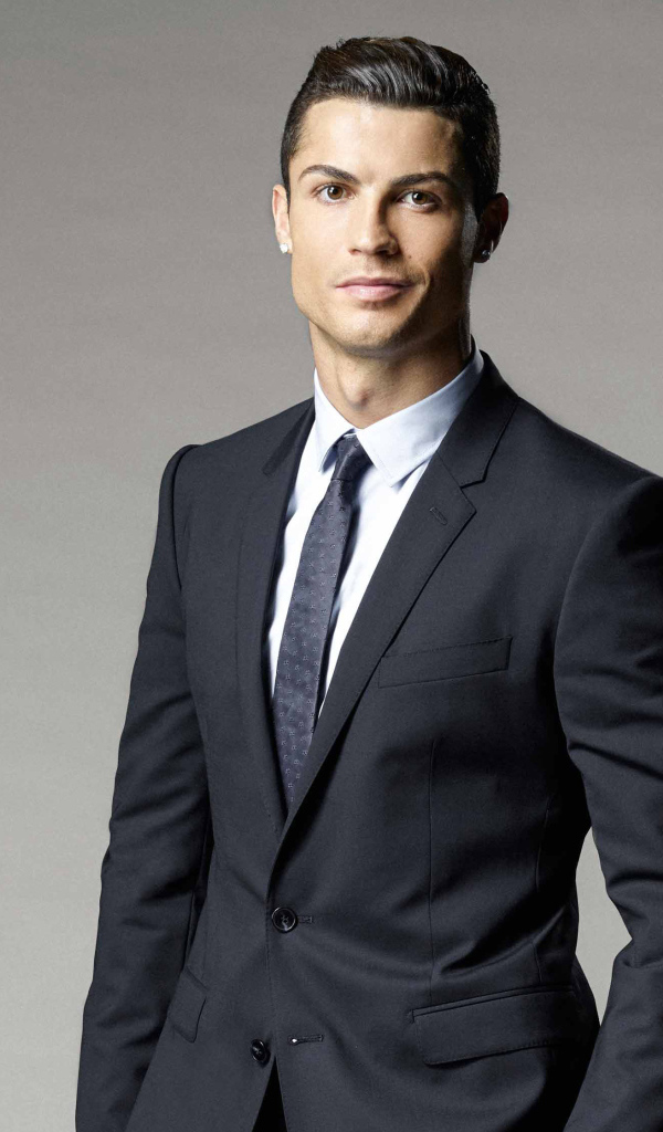 Soccer player Cristiano Ronaldo in a suit on a gray background
