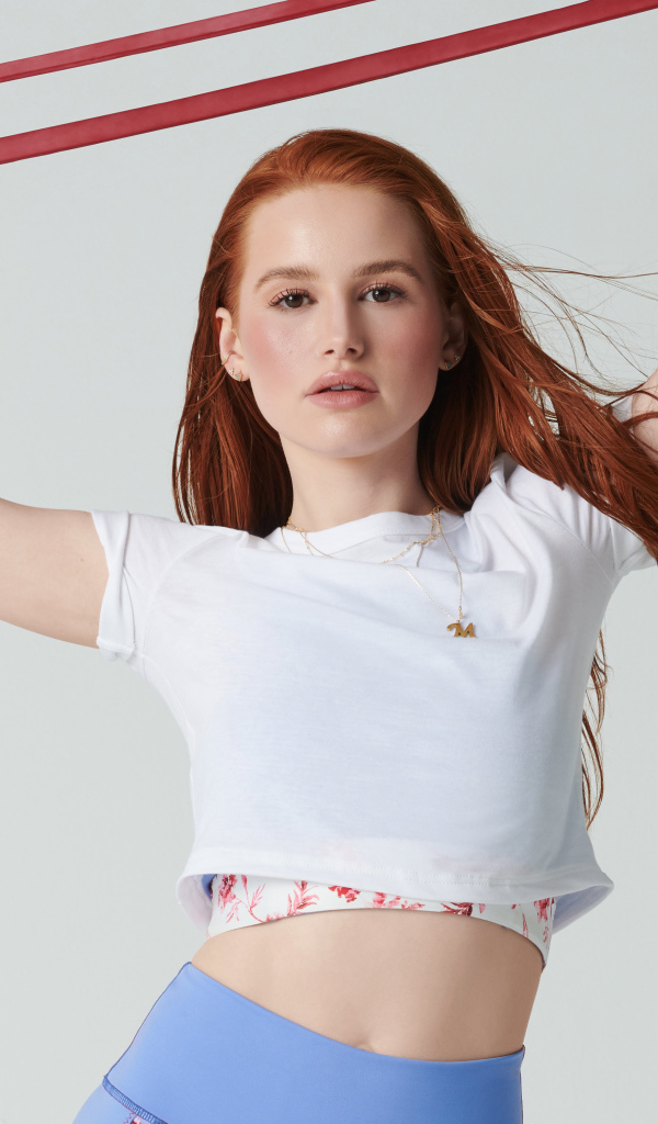 Спортивная актриса Мэделин Петш на сером фоне