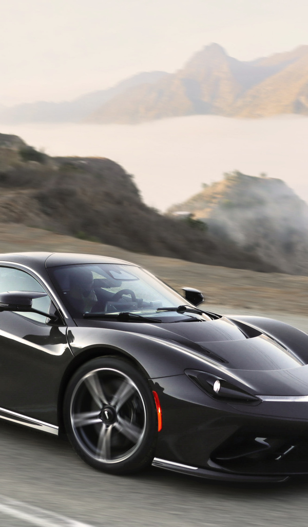 Черный спортивный автомобиль Pininfarina Battista,  2022 года на трассе