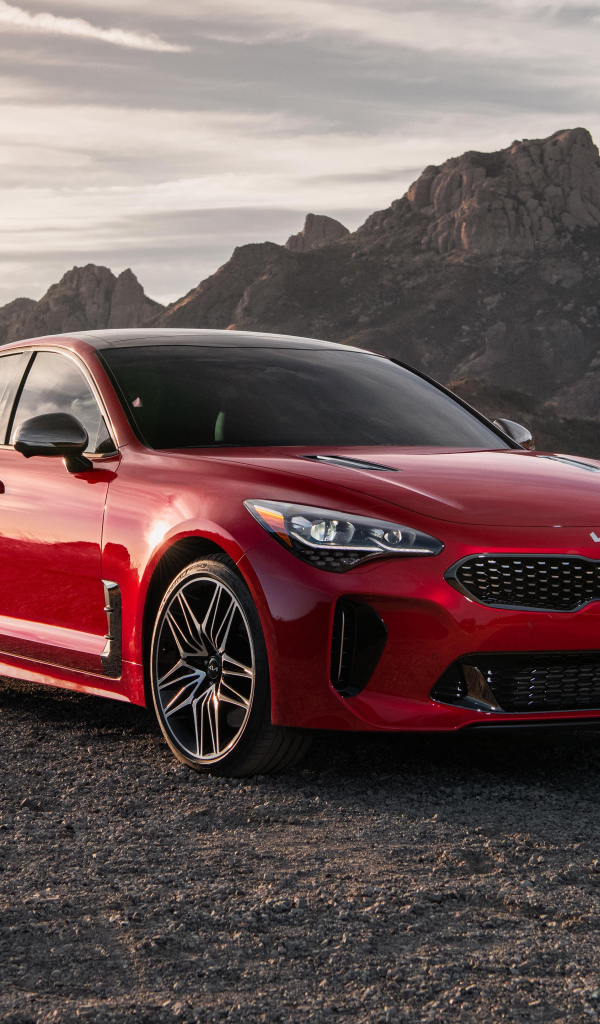 Красный автомобиль  Kia Stinger GT, 2022 года в горах