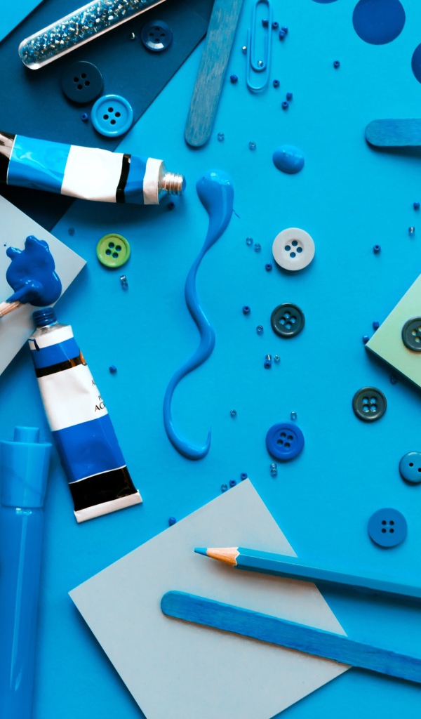 Синие канцелярские предметы, бумага и краски на столе 