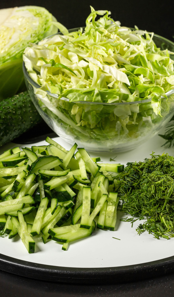 Салат с капусты на столе с огурцами и укропом 