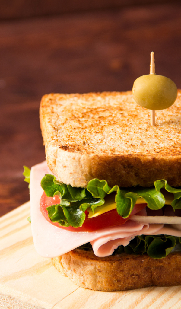 Гамбургер с ветчиной, помидорами, листьями салата и сыром