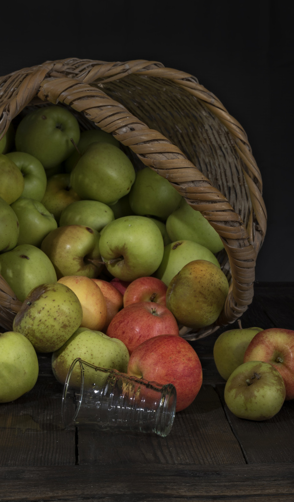 Корзина красивый спелых яблок на столе