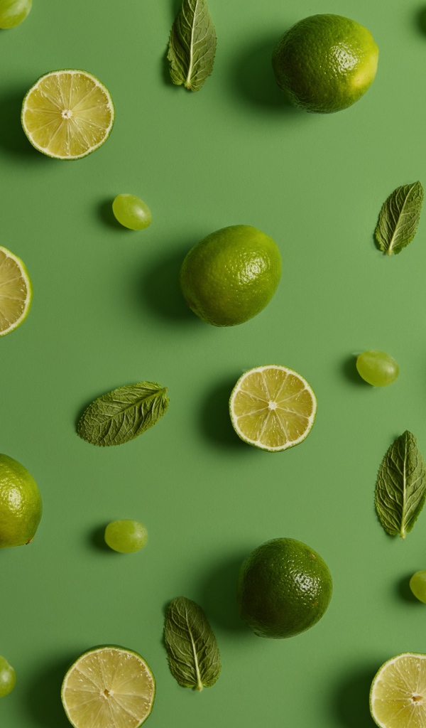 Лимоны и лаймы на зеленом фоне