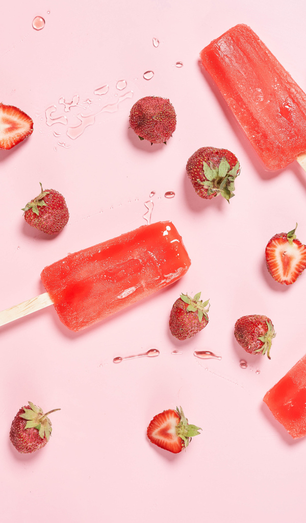 Фруктовое мороженое на розовом фоне с ягодами клубники 