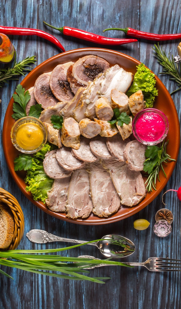 Appetizing cold cuts on the table with spices and bread