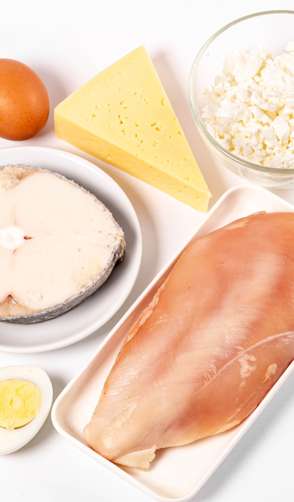 Fresh chicken, fish, nuts, cottage cheese and eggs on the table